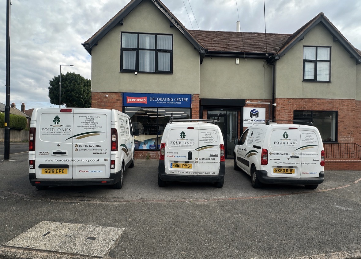 Branded Four Oaks Painting & Decorating vans outside a Sutton Coldfield decorating supplier.
